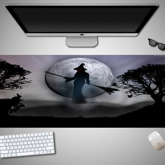 Oversized Halloween-themed gaming mouse pad on a desk, showing non-slip rubber cloth base.