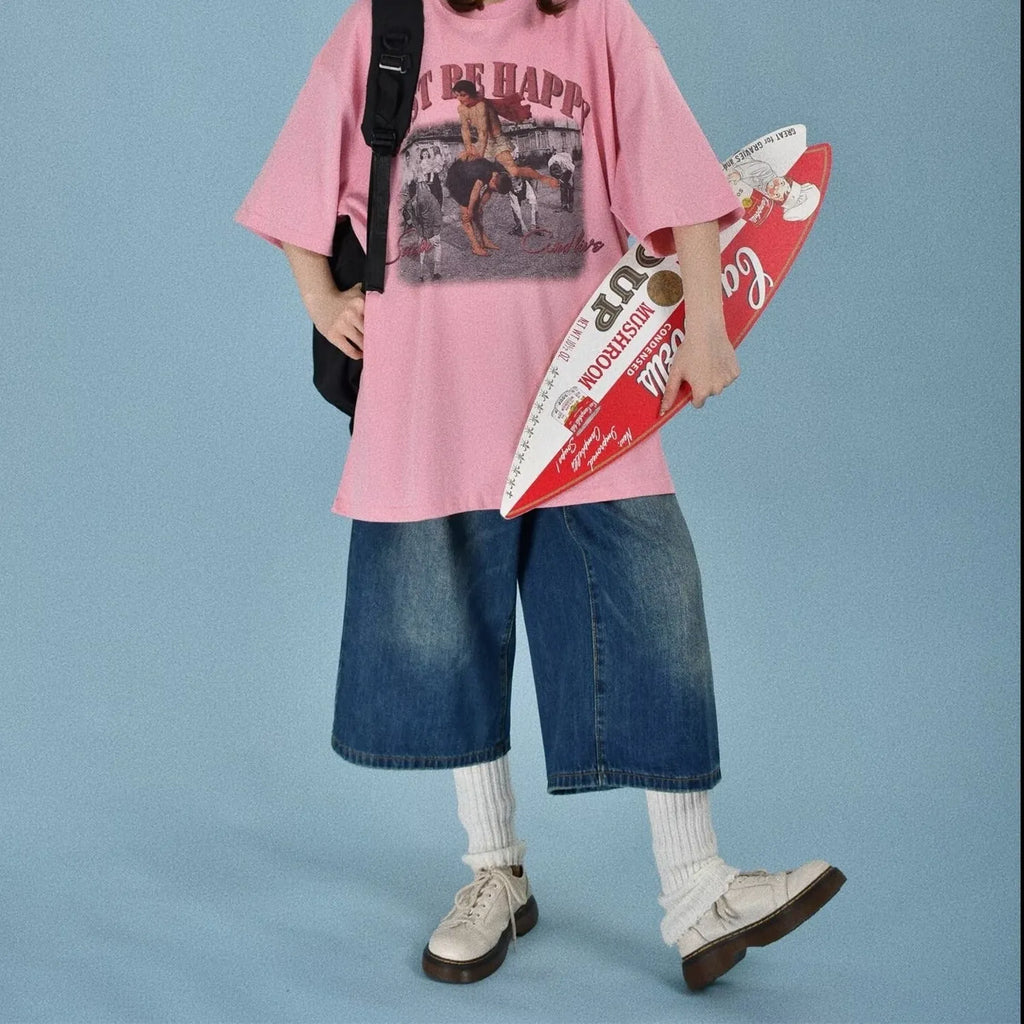 Man wearing light blue straight leg loose fit denim shorts on a summer day.