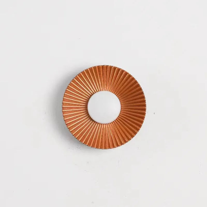 Round aluminium wall lamp mounted on a wall, showing LED illumination.
