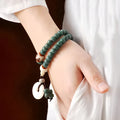 Bodhi seed beaded bracelet with a double ring safety buckle clasp featuring a Lotus detail.