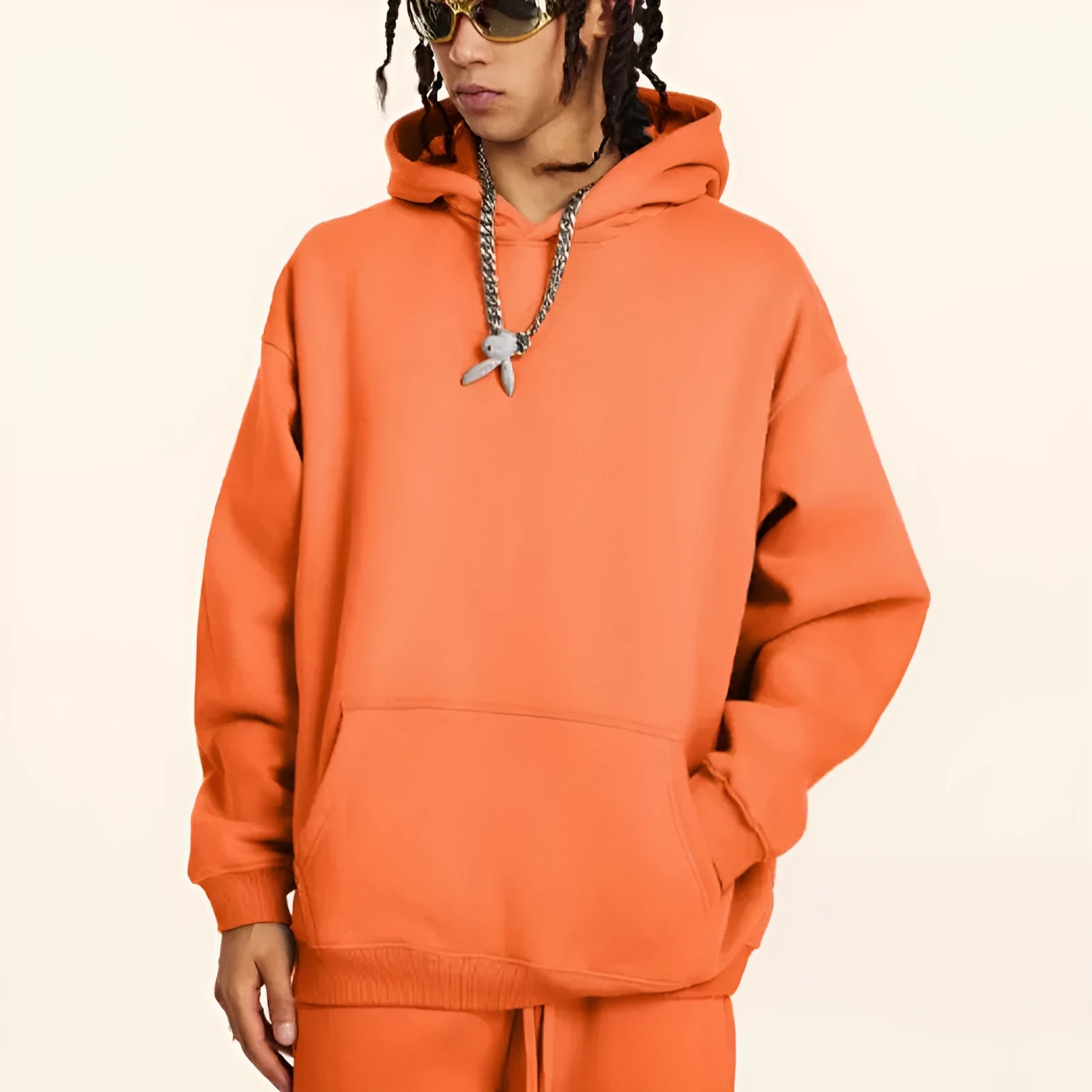 Men's loose fit cotton hooded sweater in a solid colour, showing drop-shoulder sleeves.