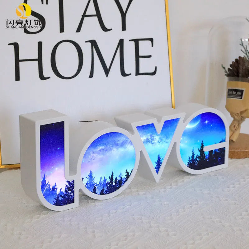 LED LOVE light with rainbow shade measuring 35.5cm, glowing softly on a wooden desk for Valentine's decoration.
