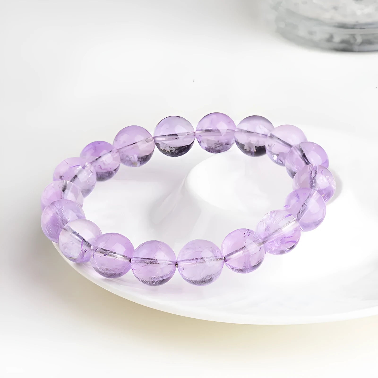 Lavender round bead amethyst bracelet with water ripple design, shown in cream and transparent colour options.