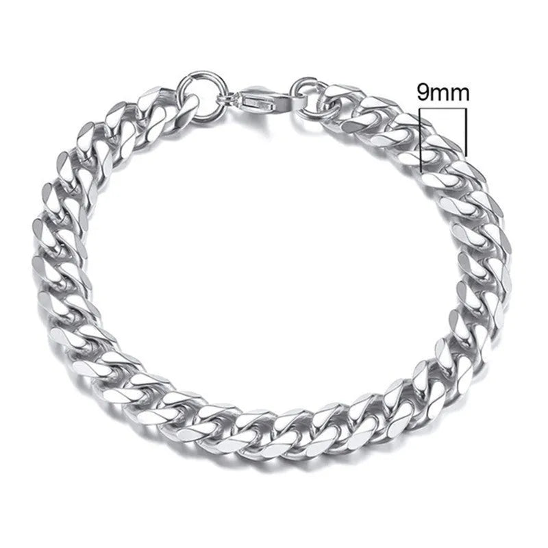Six-sided Cuban link metal bracelet in gold, black, and steel colour finishes on a wrist.