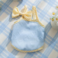 Small dog wearing heart bow suspenders vest with elastic sides in Bondi Blue colour with matching hairband