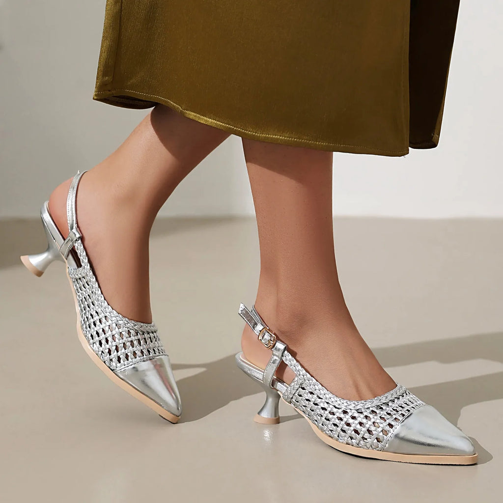Gold women's sandals with a cat heel, buckle strap, and hollowed-out design on a white background.