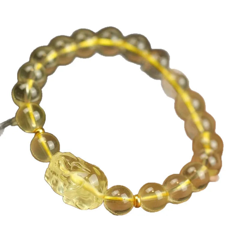 Yellow leather adjustable bracelet with a carved artificial crystal Pi Xiu charm.