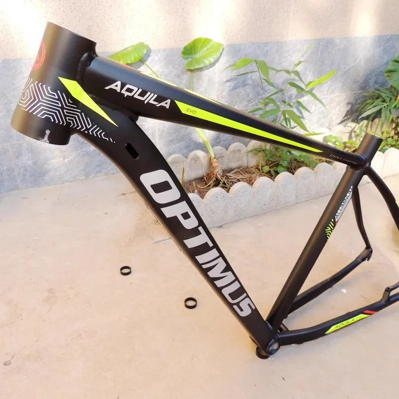 Black green aluminium mountain bike frame for 29-inch wheels with internal cable routing and disc brake mounts.