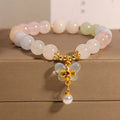 Women's adjustable crystal bracelet with a colourful morganite butterfly pendant on a white background.