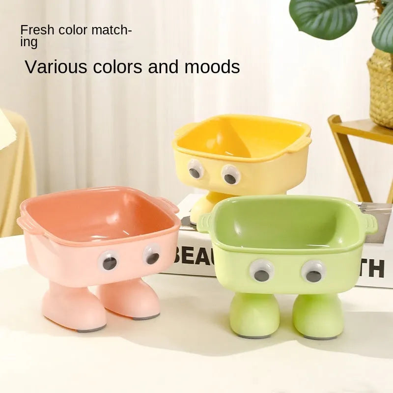 Green cartoon robot shaped elevated cat bowl with a tilted, detachable inner food dish.