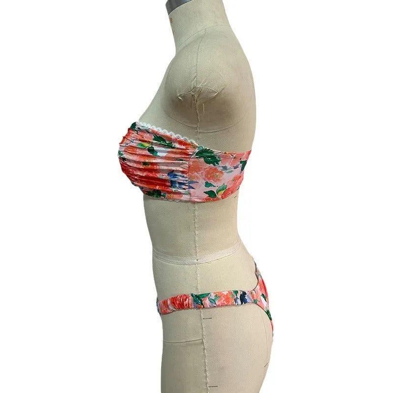 Floral print blue bikini tube top with lace trim and backless design for swimming.
