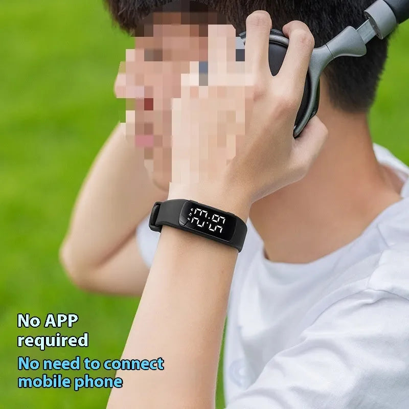 Vibration alarm clock smartwatch with a coloured silicone strap on a wrist, showing its LED display.