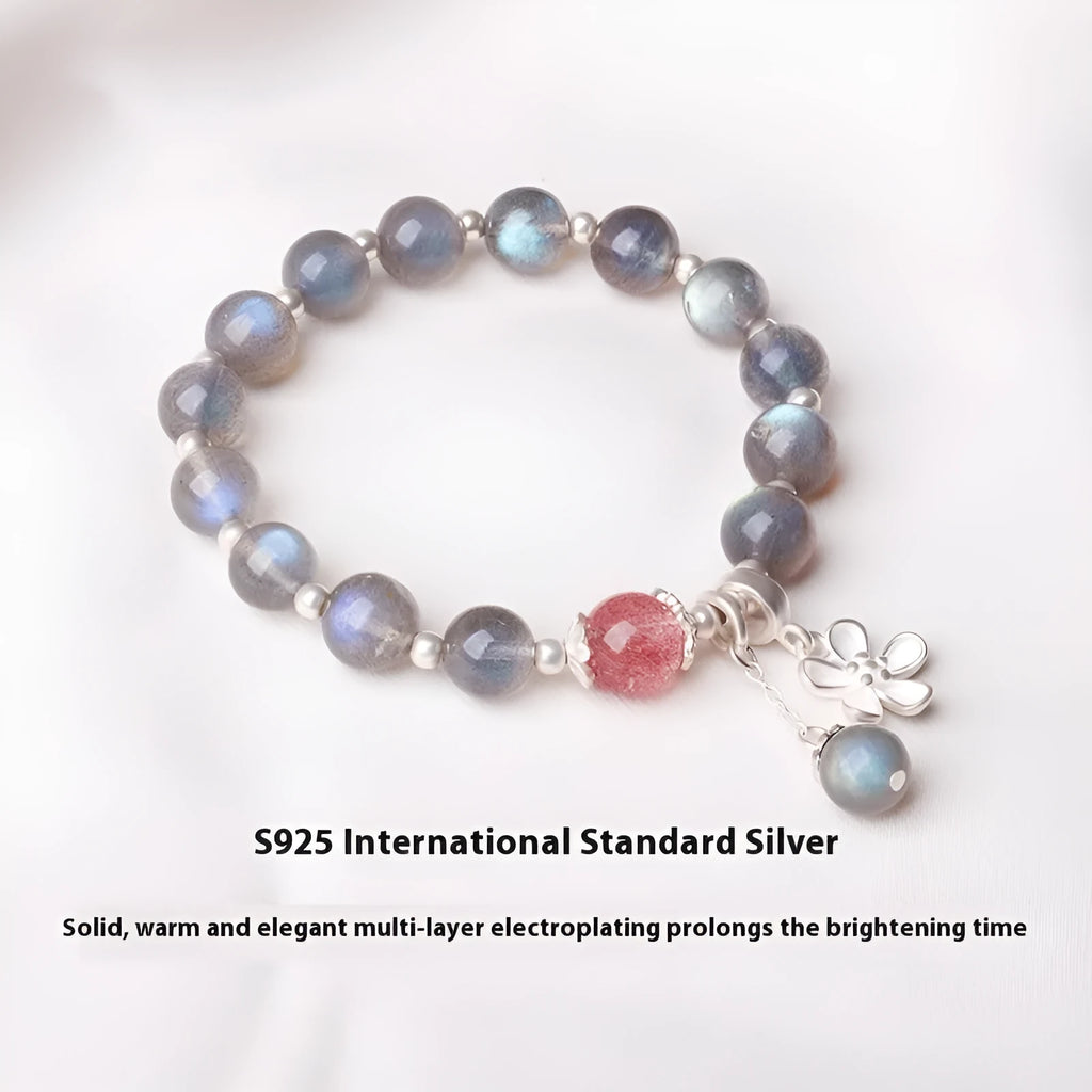 Women's bracelet with pink strawberry quartz and grey moonstone beads on a sterling silver chain with a charm.