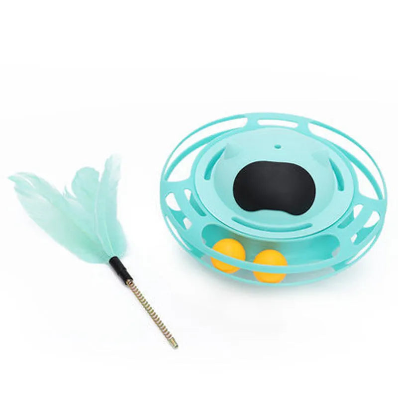 Pink plastic cat tumbler turntable toy with stick and ball on a flat surface.