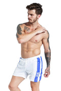 Men's blue lace-up sports shorts with slim fit and padding detail on a plain background.