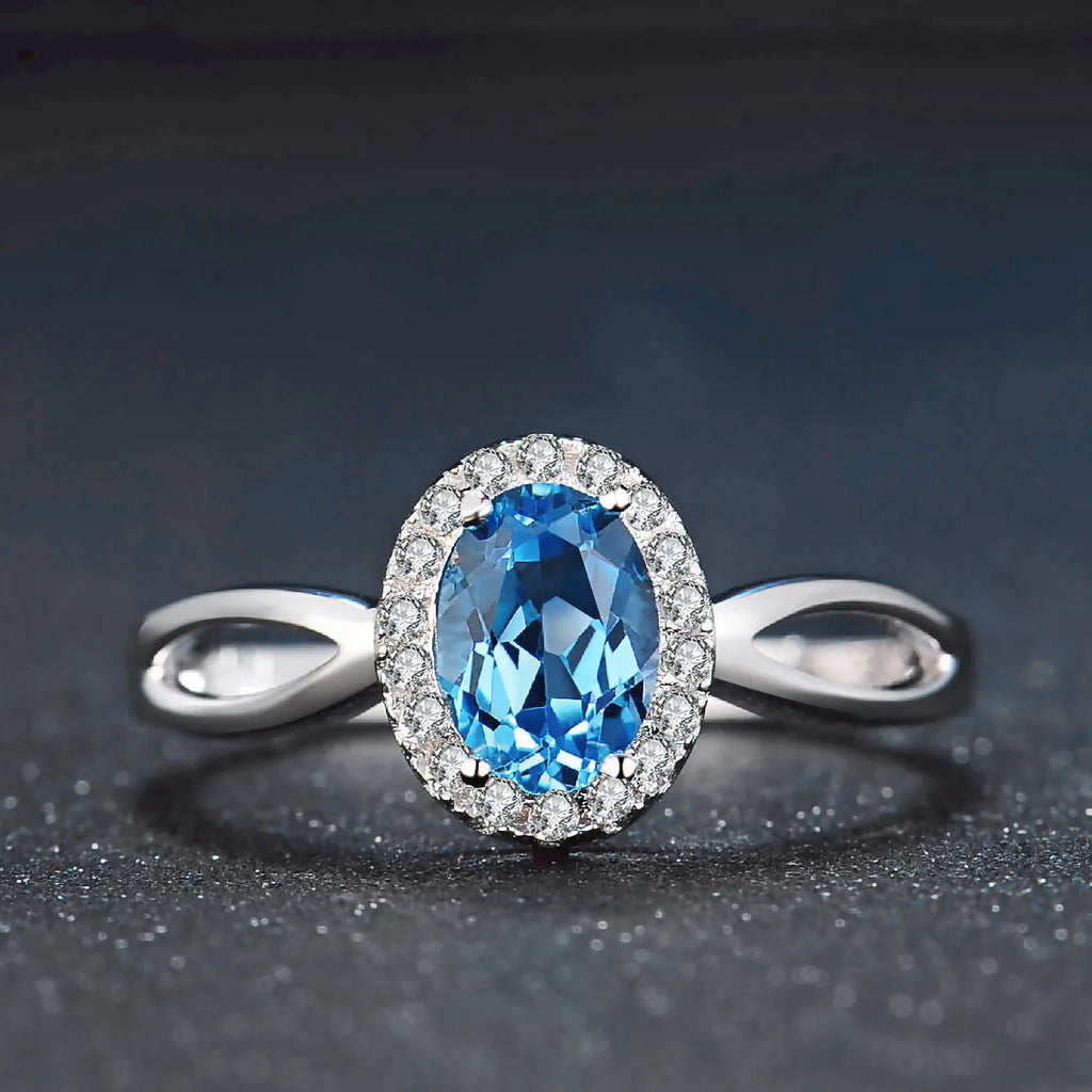 925 sterling silver jewellery set with blue topaz gemstones showing earrings, ring, pendant and necklace