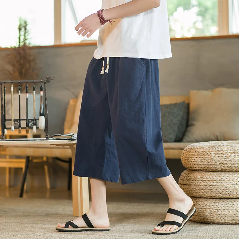 Plus size straight-leg linen shorts with skinny ankle opening in khaki, shown on a hanger.