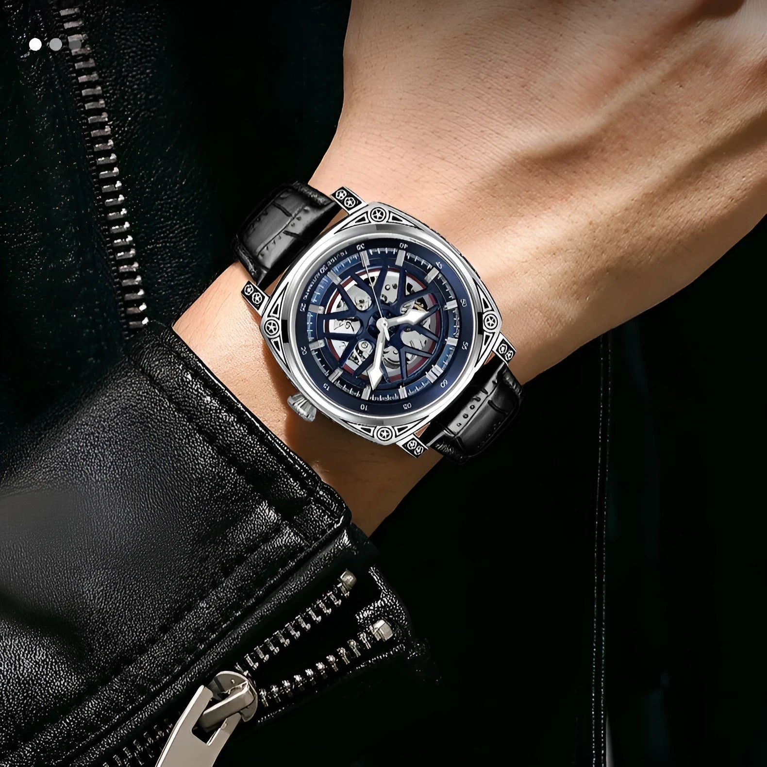 Men's stainless steel automatic watch with a blue leather strap on a wrist