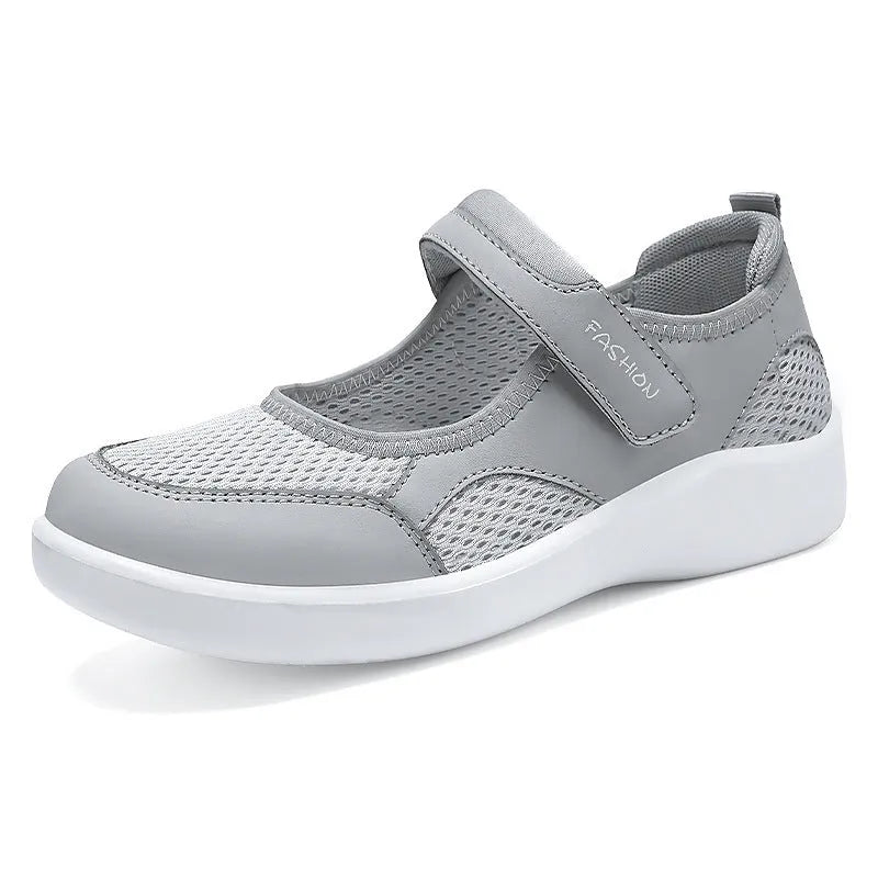 Women's low-top cloth shoes with mesh upper and Velcro strap in grey.
