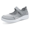 Women's low-top cloth shoes with mesh upper and Velcro strap in grey.