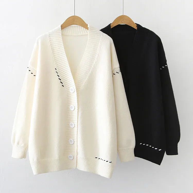 Women's loose fit knitted cardigan top coat in black or white colour with long sleeves.
