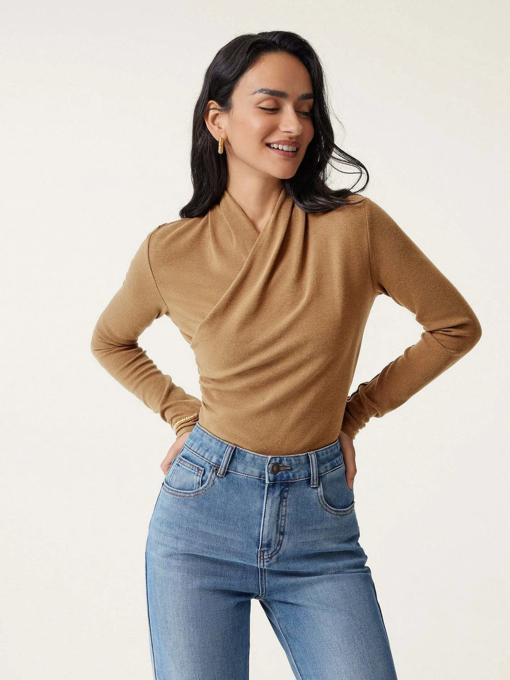 Camel-colour women's slim fit long sleeve pullover sweater on a hanger