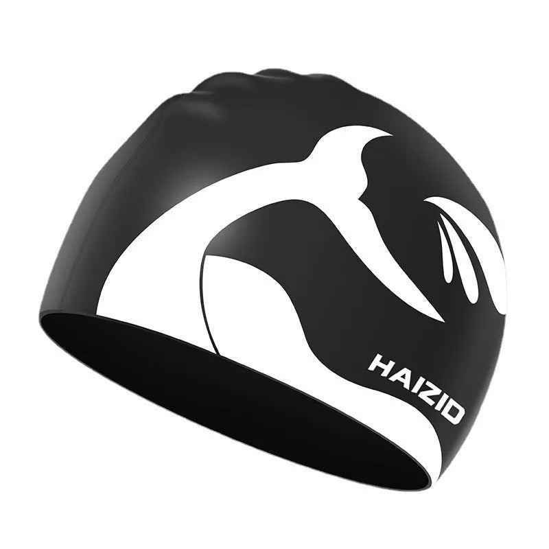 Silicone swimming cap with waterproof ear covers and a whale tail pattern in assorted colours.