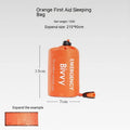 Portable orange disaster relief tent with sleeping bag and emergency blanket for outdoor use