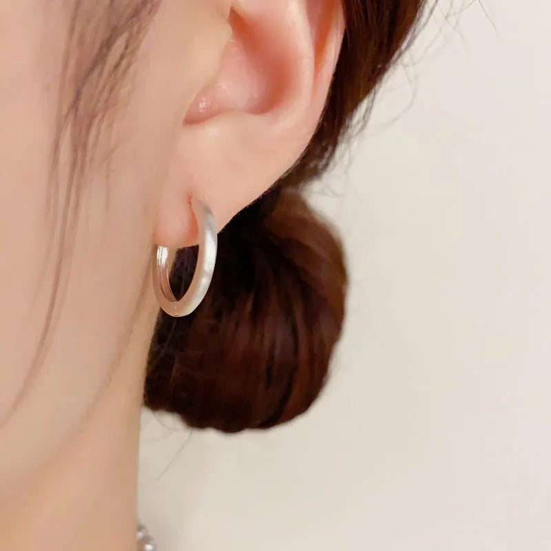 Women's geometric ear clip with round eyelet design in gold plating on copper