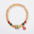 Hand-woven citrine crystal bracelet with 6mm geometric beads on a wrist