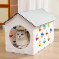 Integrated cat scratch board and nest toy with bell ball and tunnel features