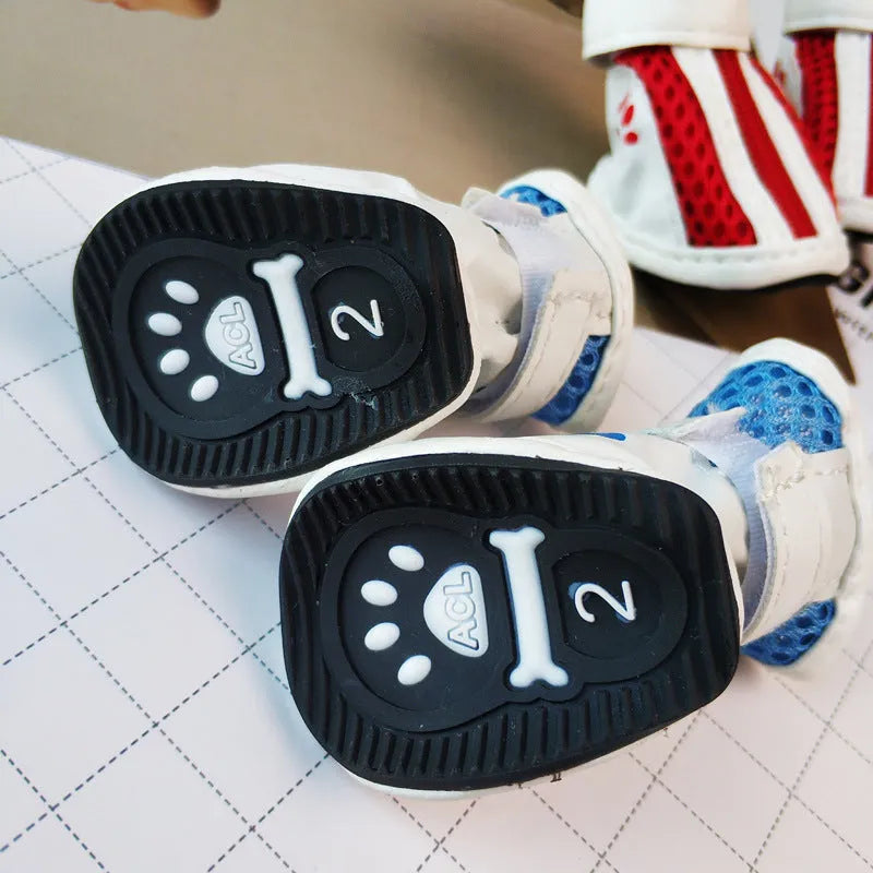 Blue zip-up cloth dog shoes with non-slip soles from a four-pair pack.