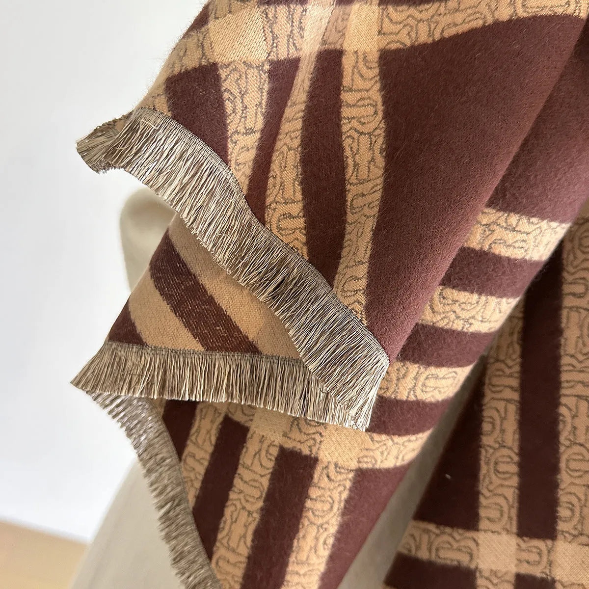 Cashmere-like scarf with tassel ends in brown colour, shown draped to display 185 cm length