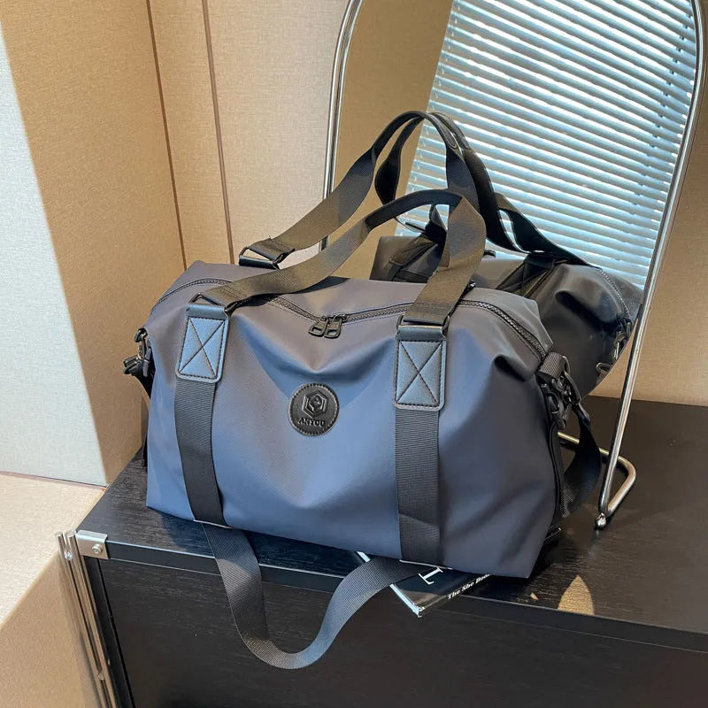 Large black waterproof Oxford cloth travel backpack with multiple compartments shown on a grey background.