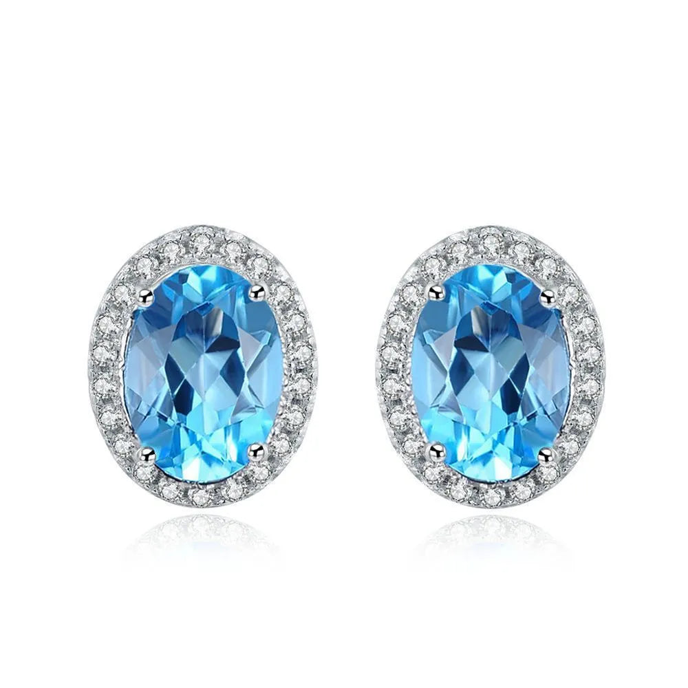 925 sterling silver jewellery set with blue topaz gemstones showing earrings, ring, pendant and necklace