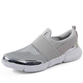 Women's low-cut casual sneakers in grey with mesh detail and PU midsole on a hard floor.