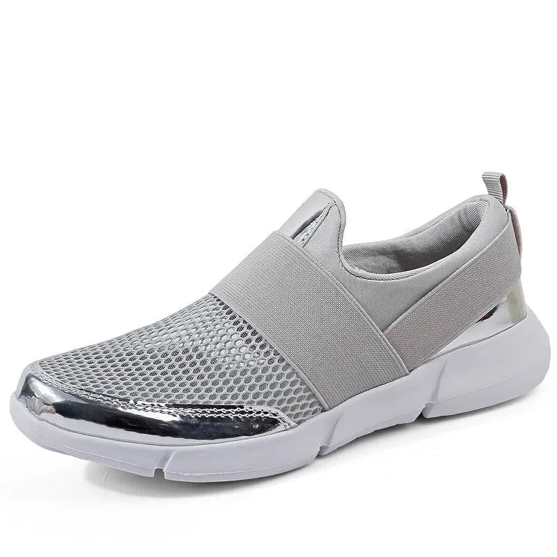 Women's low-cut casual sneakers in grey with mesh detail and PU midsole on a hard floor.