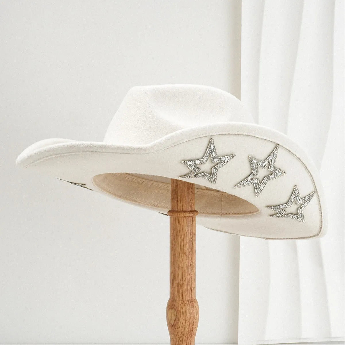 Beige polyester western-style top hat with a conical crown and a hexagonal star decoration on the side.