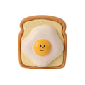 Yellow bread shaped latex dog chew toy with cartoon patterns and squeaker