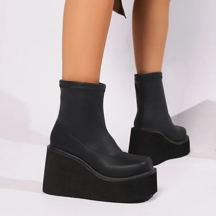 Women's black waterproof platform boots with wedge heels and round toe