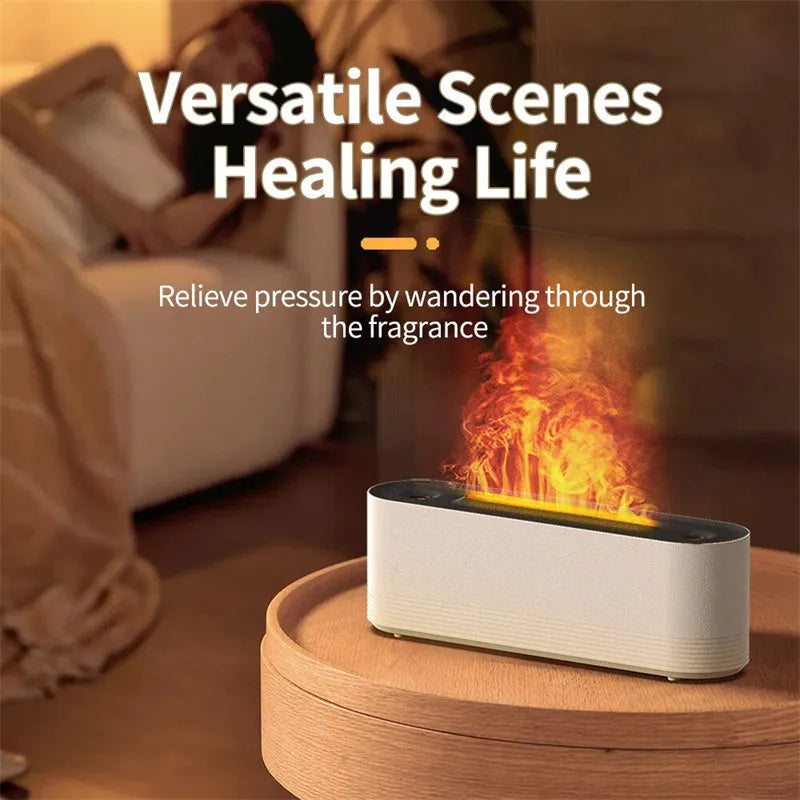 Tall black ultrasonic aroma diffuser with coloured flame LED light and rising water mist on a desk.