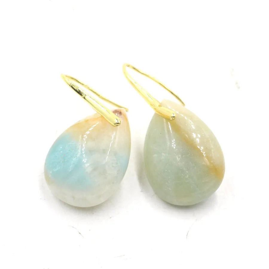 Geometric water drop shaped crystal earrings on an electroplated setting, shown in various colour options.