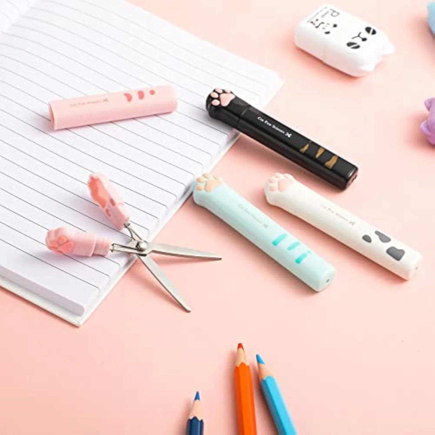 Mini folding scissors with cat paw design on handle, shown in pink, white, black, and blue colour options.