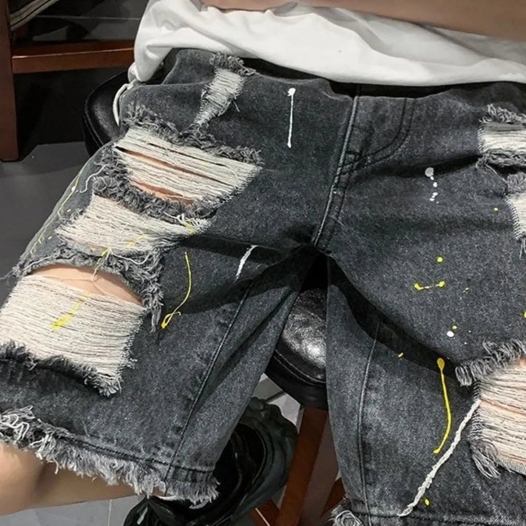 Men's loose fit denim shorts with water washed finish and distressed holes in light blue colour
