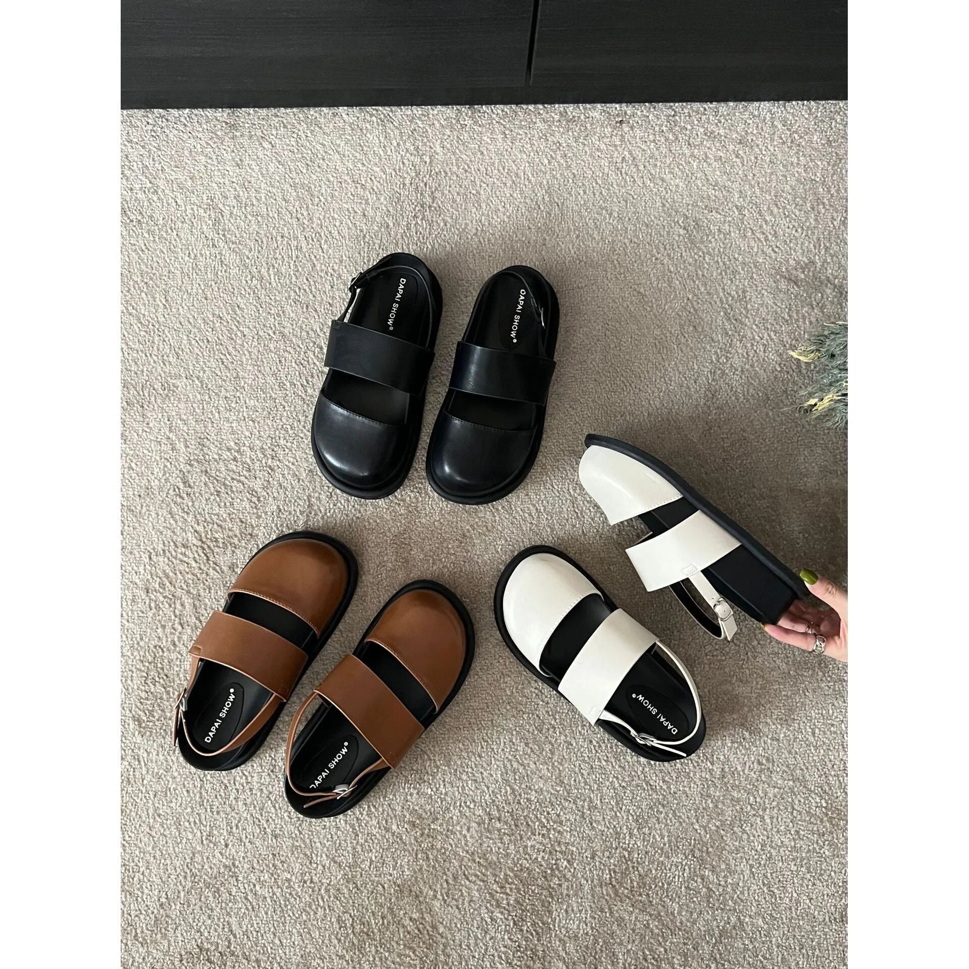 Retro closed-toe sandals with an adjustable ankle strap buckle in black, brown, or apricot colour.