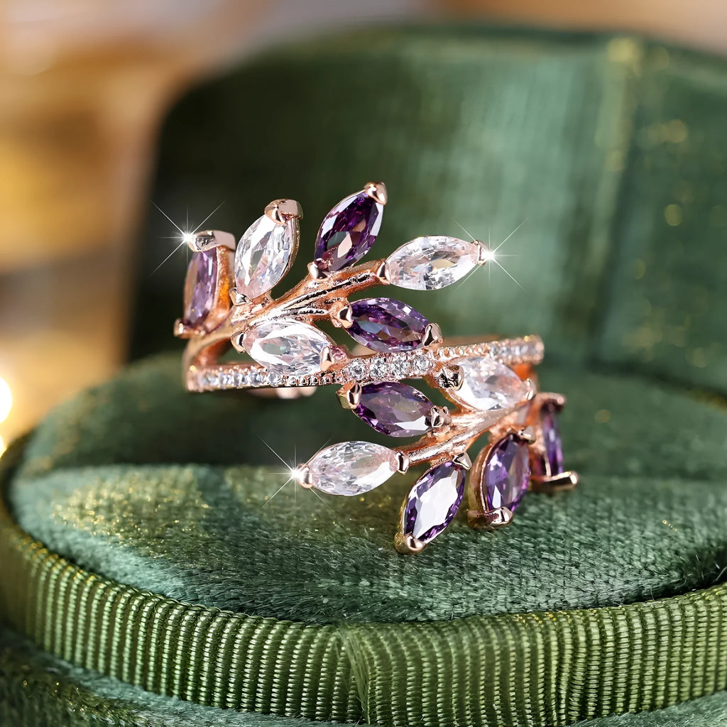 Copper leaf-shaped fashion ring with zircon details and an adjustable opening, shown in a rose gold finish.
