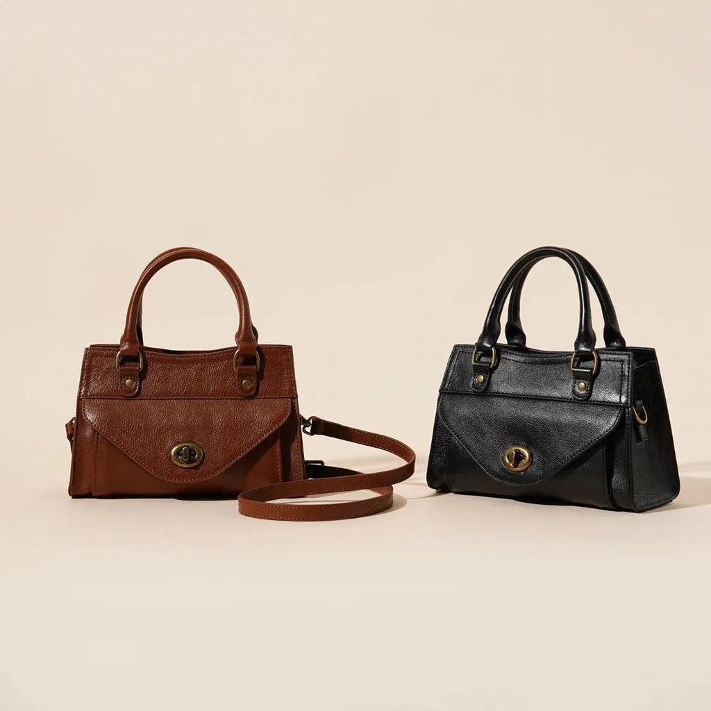 Genuine leather one-shoulder crossbody bag in solid colour with lock closure, horizontal square shape, and visible sewing thread details.