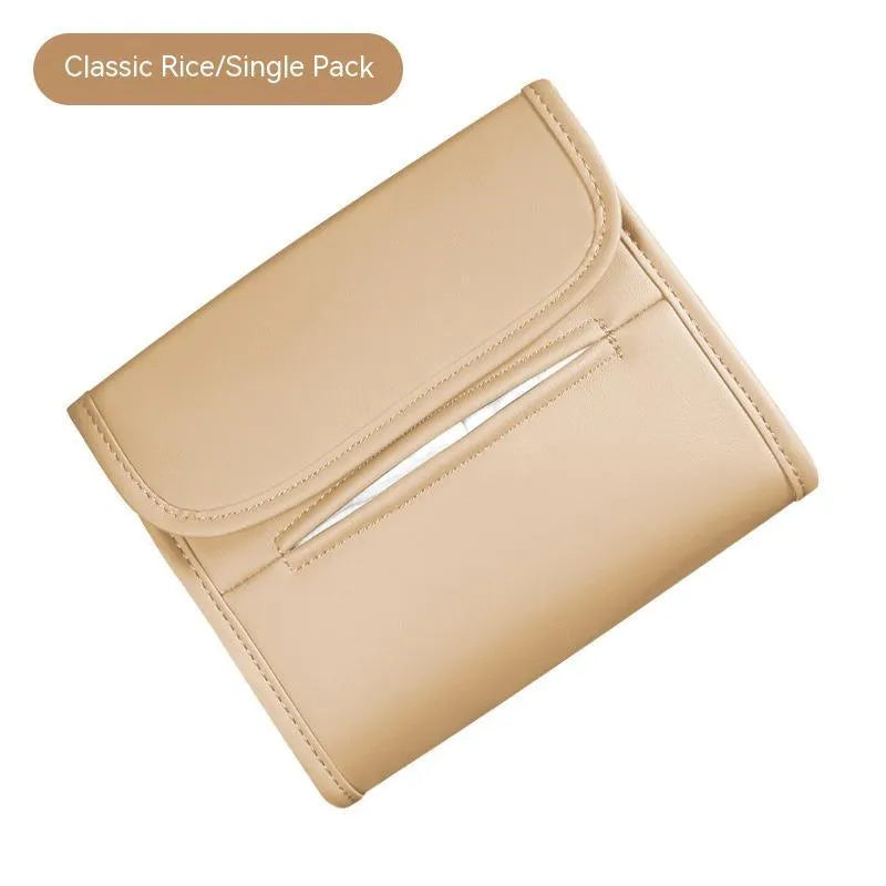 Brown leather car tissue box with elastic strap hanging on a car armrest