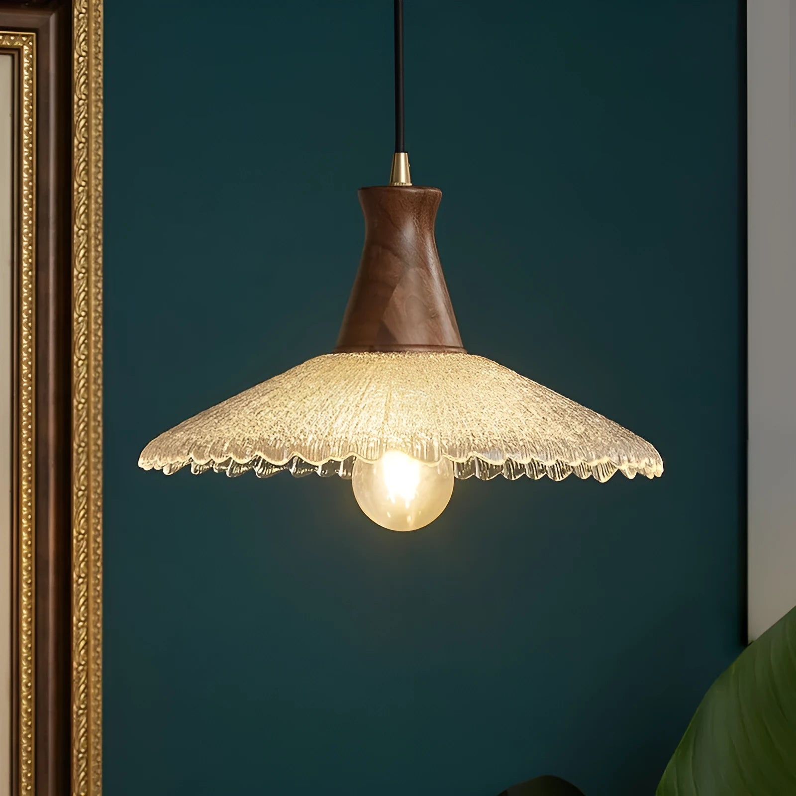 Retro wooden ceiling lamp with brass details and glass shade shown in a dining setting