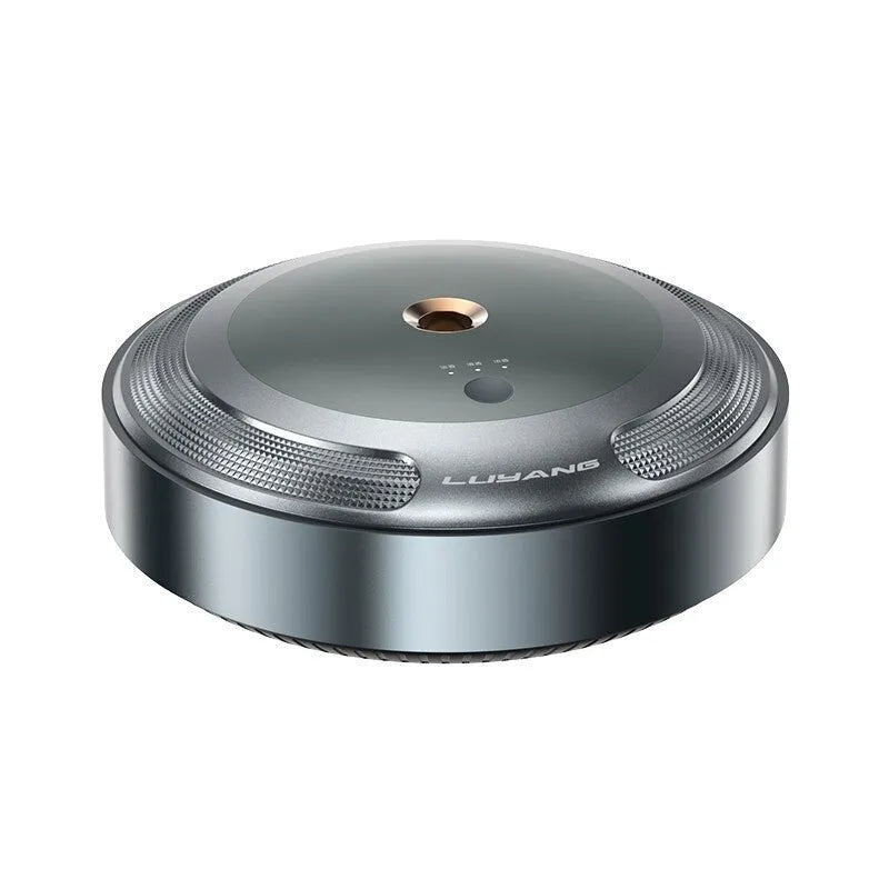Silver automatic car air freshener diffuser with zinc alloy metal shell on anti-slip pad.